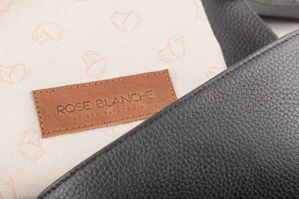 bandolera-ana-cuero-vacuno-negro-interior-forro-bolsa-rose-blanche.jpg Interior Bandolera Ana Rose Blanche cuero vacuno negro, forro estampado con patrón Rose Blanche y bolsa de cuidados incluida, artesanal Patagonia